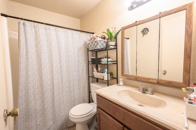 bathroom featuring vanity, a shower with shower curtain, a textured ceiling, and toilet