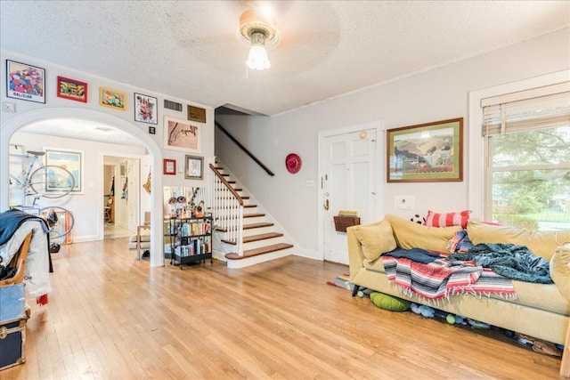 interior space with ceiling fan, hardwood / wood-style floors, and a textured ceiling