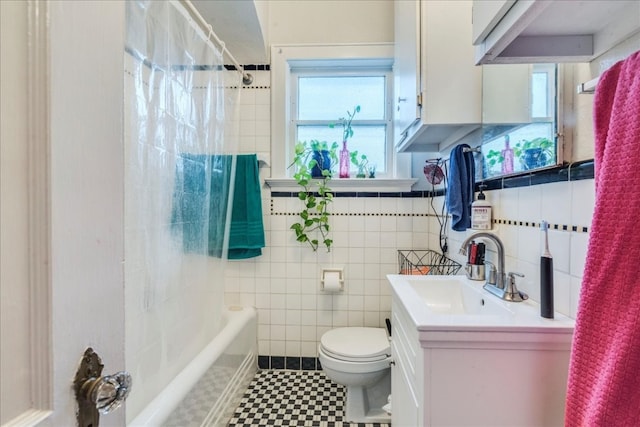 full bathroom with vanity, toilet, shower / bath combo with shower curtain, and tile walls