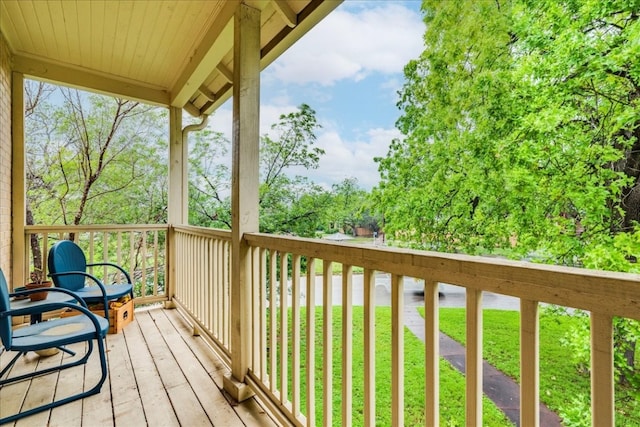 wooden terrace with a lawn