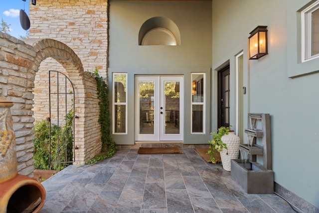 entrance to property featuring french doors and a patio area