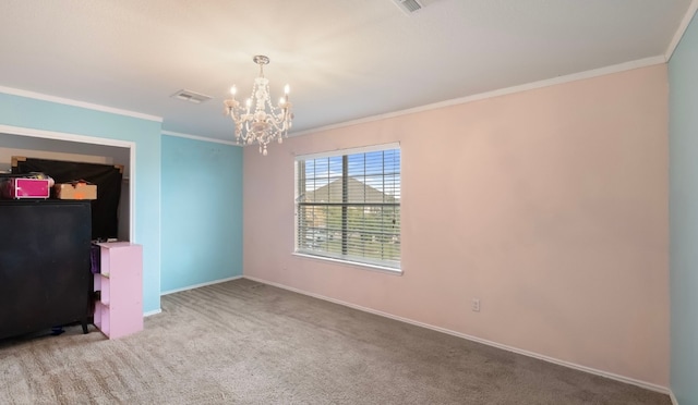 spare room featuring ornamental molding, light carpet, and a chandelier