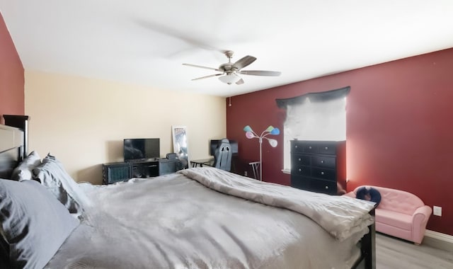 bedroom with light hardwood / wood-style flooring and ceiling fan