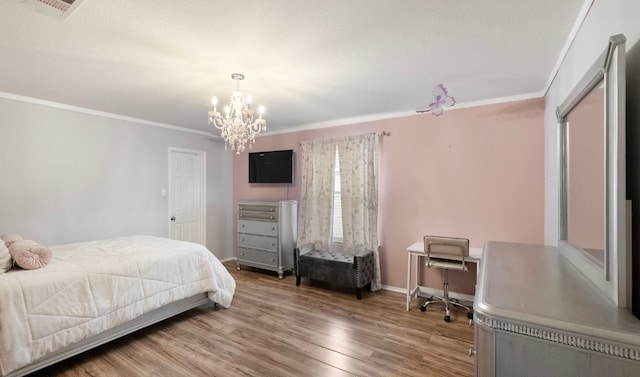 bedroom featuring hardwood / wood-style flooring, ornamental molding, and a chandelier