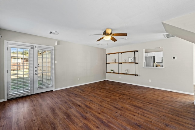 unfurnished living room with french doors, ceiling fan, and dark wood-type flooring