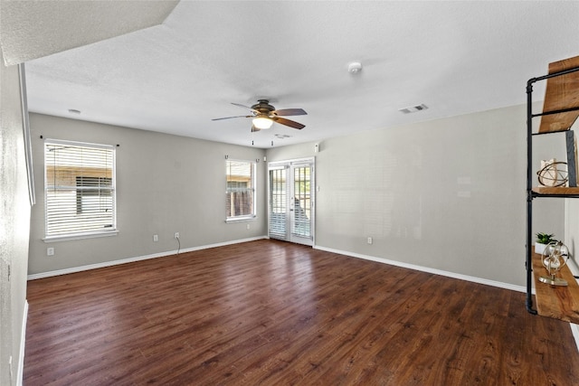 spare room featuring ceiling fan, dark hardwood / wood-style flooring, and a textured ceiling