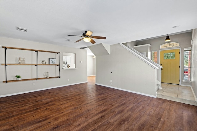 unfurnished living room with ceiling fan and hardwood / wood-style floors