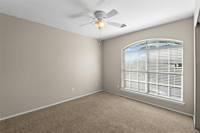 carpeted empty room featuring ceiling fan