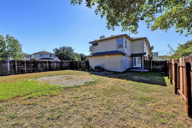 back of house with french doors, a yard, and central AC unit