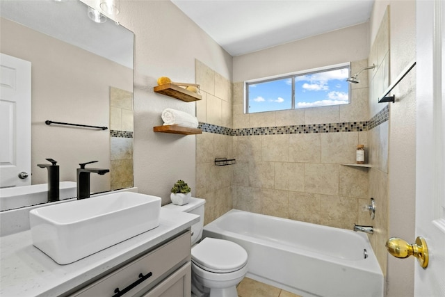 full bathroom with tile patterned flooring, vanity, toilet, and tiled shower / bath