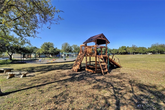 view of jungle gym featuring a lawn