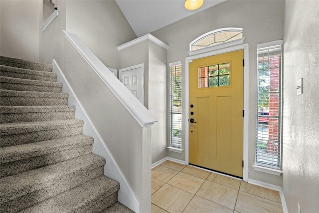 tiled entryway with vaulted ceiling