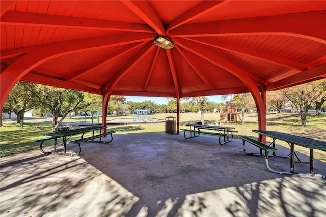 view of community featuring a playground and a patio area