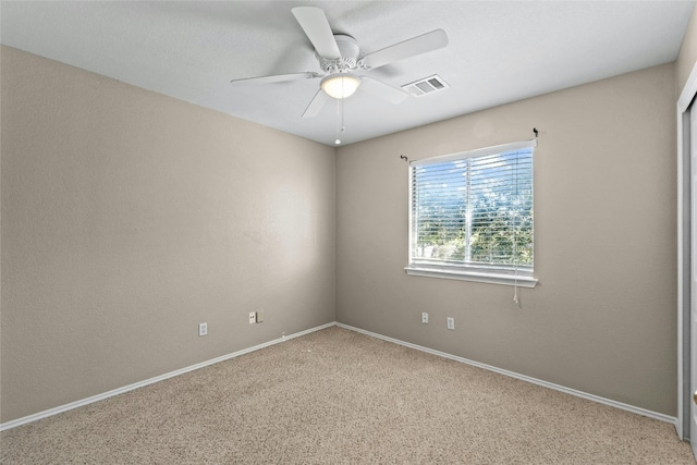 spare room featuring ceiling fan and carpet floors