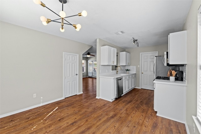 kitchen with backsplash, stainless steel appliances, white cabinetry, and dark wood-type flooring