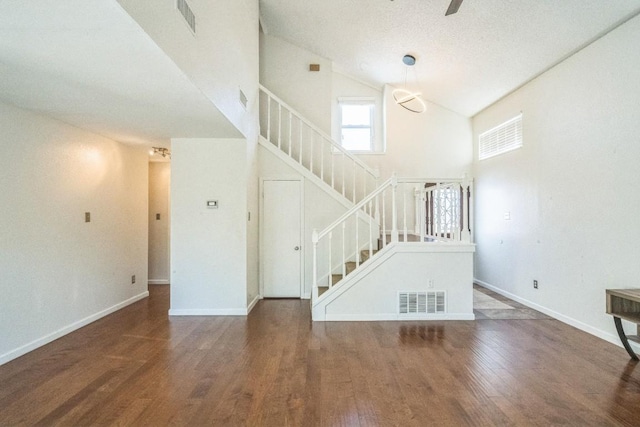 interior space featuring dark hardwood / wood-style floors and high vaulted ceiling