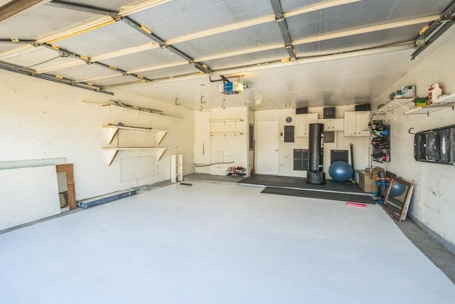 garage with electric panel and a garage door opener