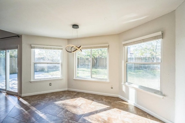 unfurnished dining area with a notable chandelier