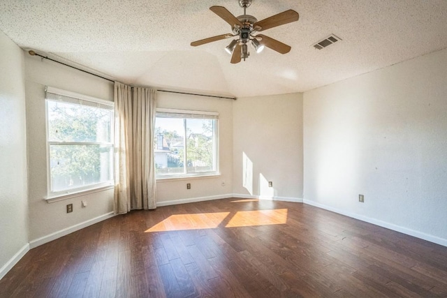 unfurnished room featuring ceiling fan, dark hardwood / wood-style flooring, a textured ceiling, and vaulted ceiling