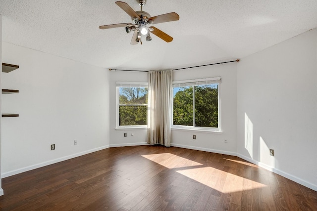 empty room featuring ceiling fan, dark hardwood / wood-style flooring, and a textured ceiling