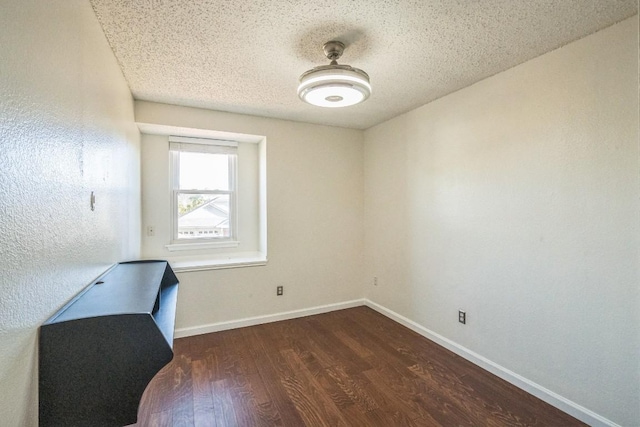 office space featuring dark wood-type flooring and a textured ceiling