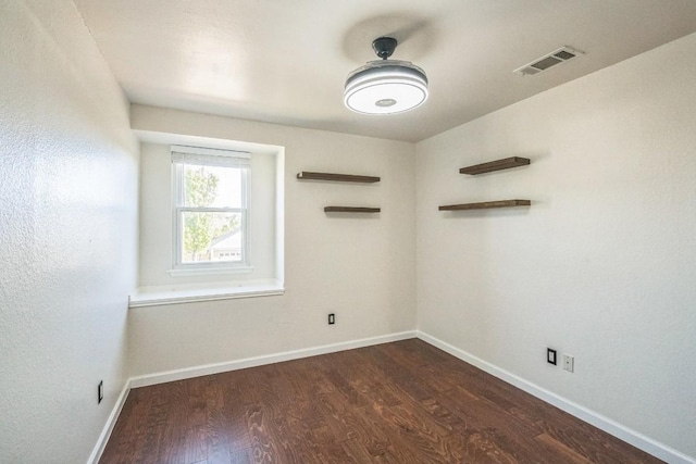 empty room featuring dark hardwood / wood-style flooring