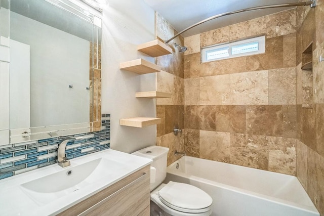 full bathroom featuring decorative backsplash, vanity, tiled shower / bath combo, and toilet