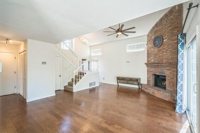 unfurnished living room featuring ceiling fan, a fireplace, and dark hardwood / wood-style floors