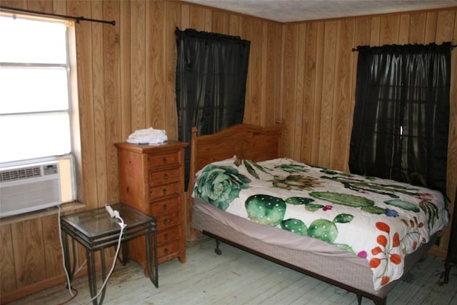181 N Main St, Paige, TX 78659 - bedroom with wood walls, wood finished floors, and cooling unit