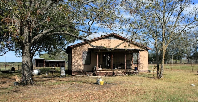 181 N Main St, Paige, TX 78659 - view of front of house with a front lawn and an outbuilding