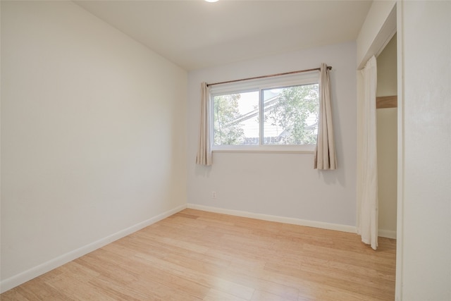 spare room featuring light hardwood / wood-style flooring