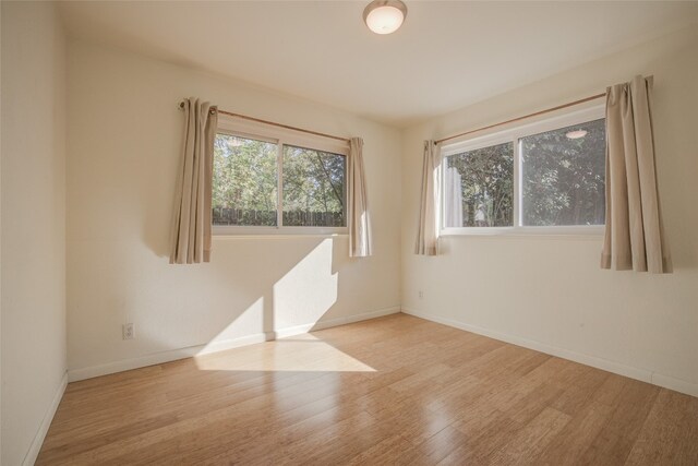 unfurnished room with light hardwood / wood-style flooring