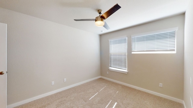 carpeted spare room with ceiling fan