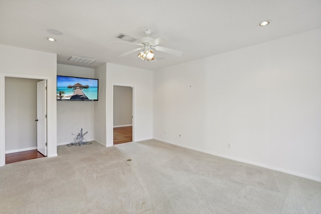 unfurnished bedroom with ceiling fan and light colored carpet