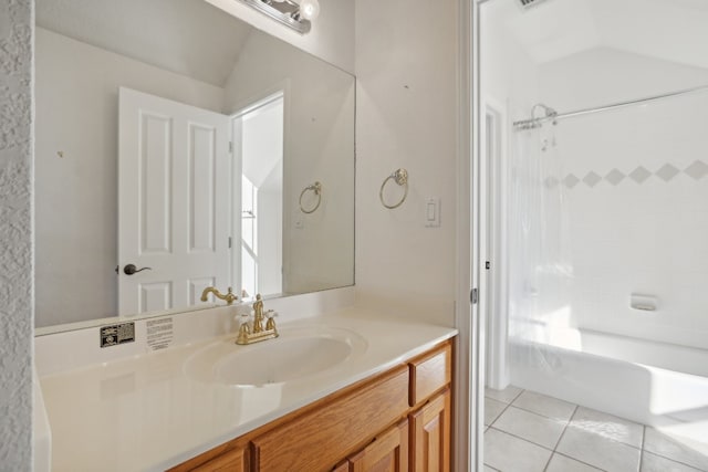 bathroom with tile patterned flooring, vanity, vaulted ceiling, and tub / shower combination