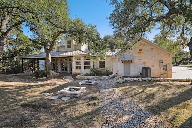 rear view of property featuring central air condition unit