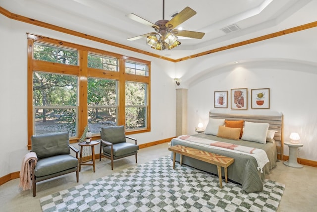 bedroom featuring ceiling fan, crown molding, and light colored carpet