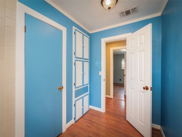 hallway featuring crown molding and hardwood / wood-style floors