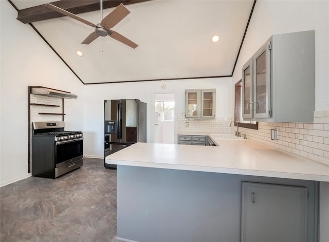 kitchen featuring lofted ceiling with beams, sink, stainless steel gas range, black fridge with ice dispenser, and kitchen peninsula