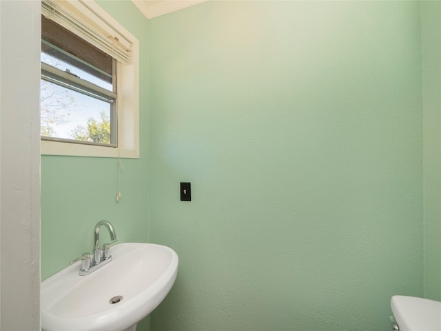 bathroom with toilet and sink