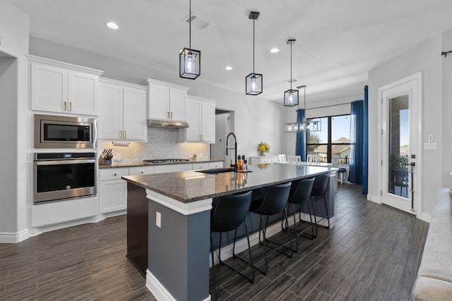 kitchen featuring white cabinetry, sink, an island with sink, and stainless steel appliances