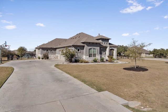 view of front of home with a front yard and a garage