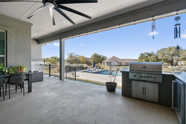 view of patio with ceiling fan, exterior kitchen, and a grill