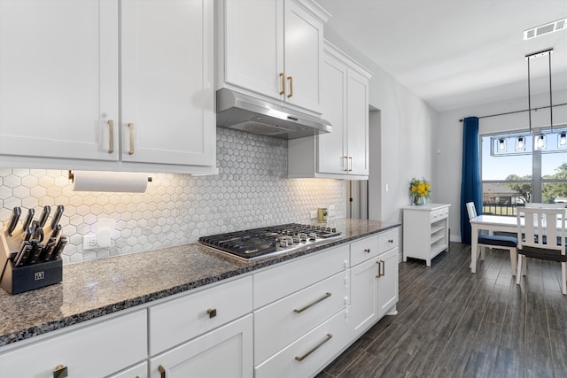 kitchen featuring decorative backsplash, stainless steel gas cooktop, dark wood-type flooring, decorative light fixtures, and white cabinets