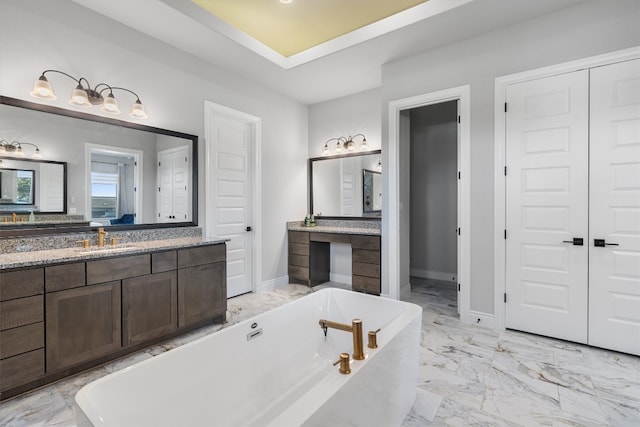 bathroom with a washtub and vanity