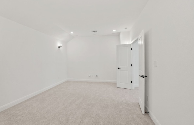 empty room with baseboards, visible vents, recessed lighting, and light colored carpet