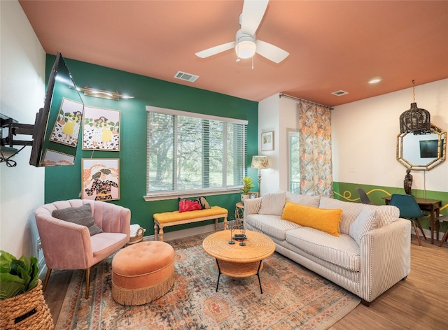 living room with hardwood / wood-style flooring and ceiling fan