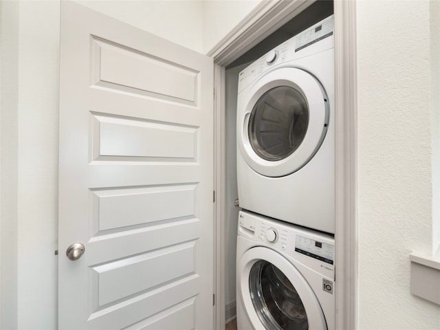 laundry room with stacked washing maching and dryer