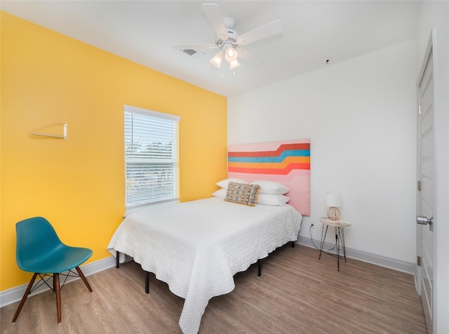 bedroom featuring ceiling fan and hardwood / wood-style flooring