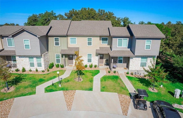 18802 Nicklaus Dr, Lago Vista, TX 78645 - multi unit property with stone siding, a front lawn, and roof with shingles